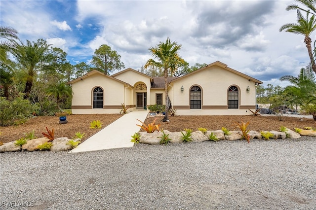 view of front facade featuring driveway and stucco siding