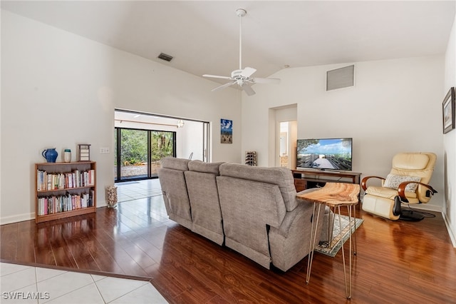 living room featuring high vaulted ceiling, ceiling fan, visible vents, and wood finished floors