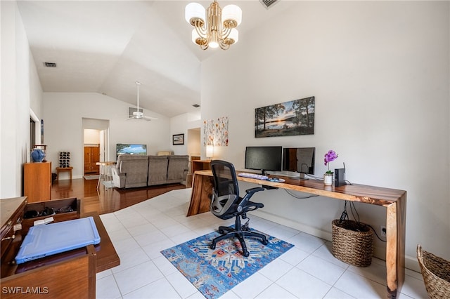 office featuring high vaulted ceiling, ceiling fan with notable chandelier, visible vents, and tile patterned floors