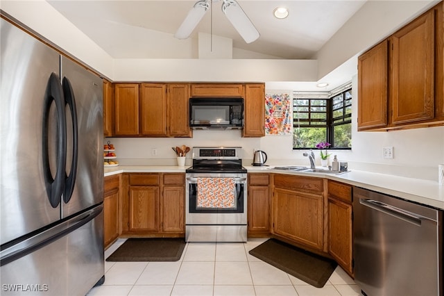 kitchen featuring appliances with stainless steel finishes, brown cabinets, light countertops, and a sink