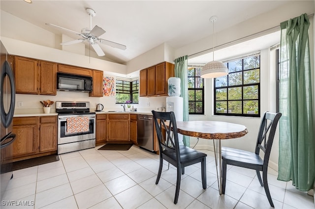 kitchen featuring black appliances, brown cabinetry, and light countertops