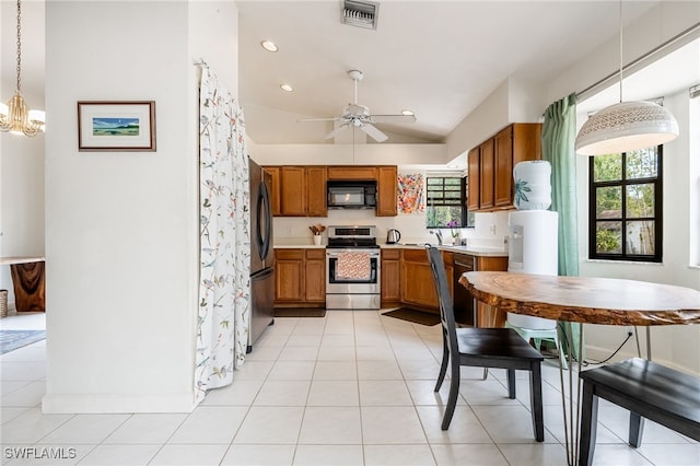 kitchen with black appliances, light countertops, visible vents, and brown cabinets