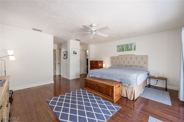 bedroom featuring visible vents, baseboards, and wood finished floors