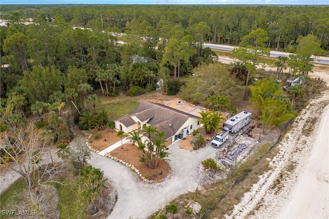 birds eye view of property featuring a wooded view