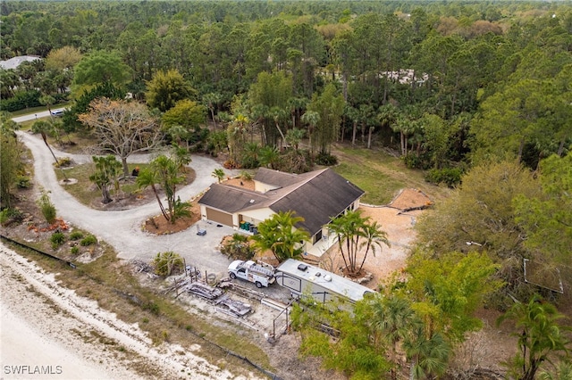 birds eye view of property with a view of trees