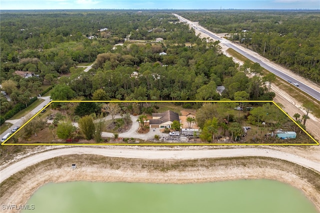 bird's eye view featuring a water view and a view of trees