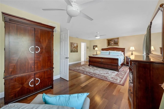 bedroom with visible vents, ceiling fan, baseboards, and wood finished floors