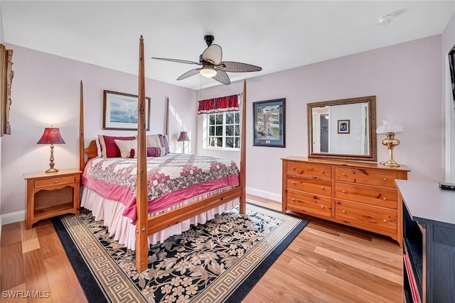 bedroom featuring a ceiling fan, light wood-type flooring, and baseboards