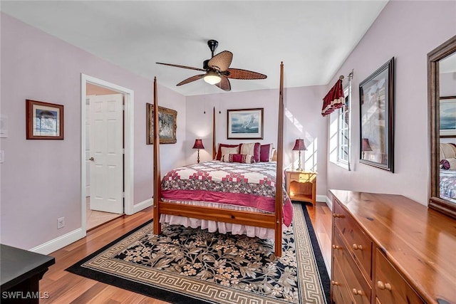 bedroom with ceiling fan, baseboards, and wood finished floors