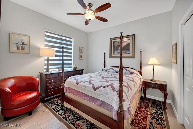 bedroom featuring light wood-style flooring, baseboards, and a ceiling fan