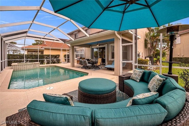 outdoor pool featuring a ceiling fan, a patio area, an in ground hot tub, a lanai, and an outdoor living space