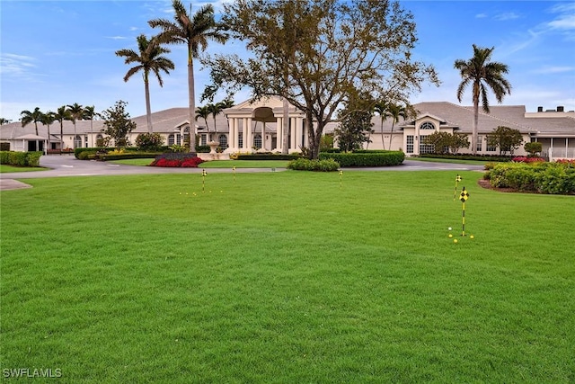 view of property's community with a lawn