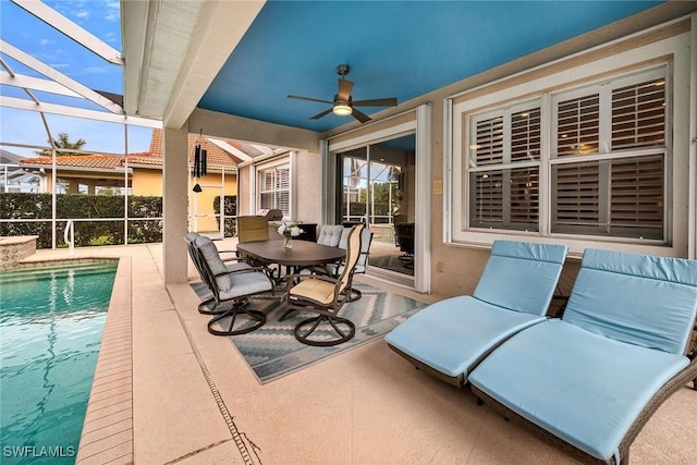 view of patio featuring ceiling fan, a lanai, and a fenced in pool