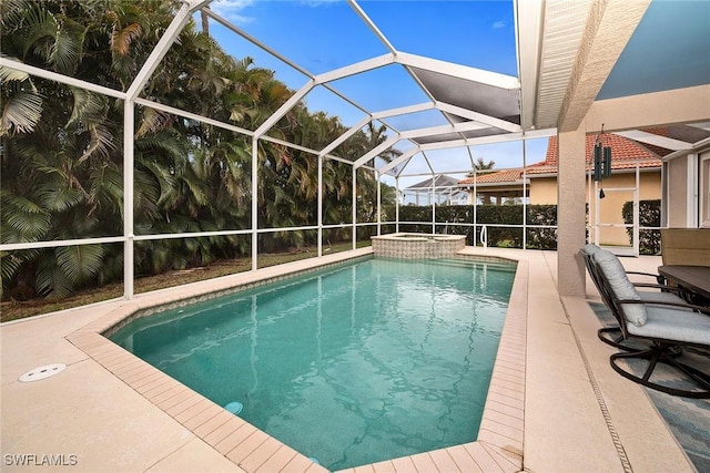 view of swimming pool with a lanai, a patio area, and a pool with connected hot tub