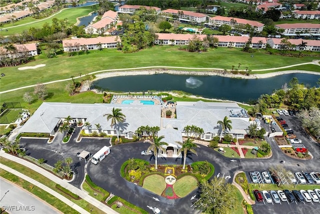 drone / aerial view with a water view and a residential view