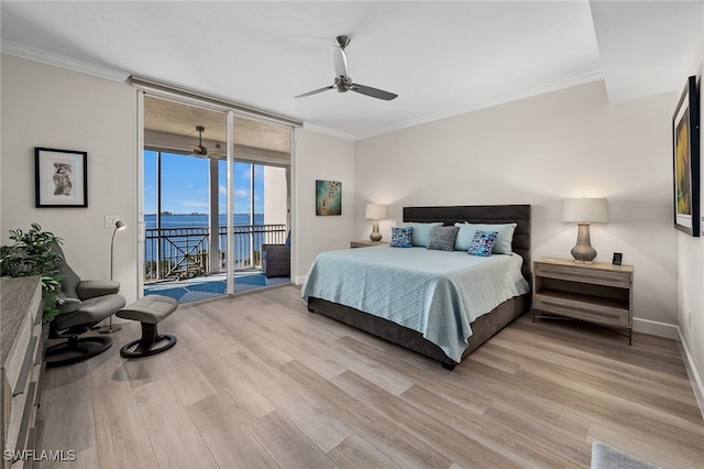 bedroom featuring access to outside, a wall of windows, and crown molding