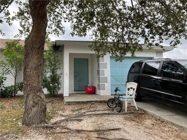 view of front of house featuring a garage and stucco siding