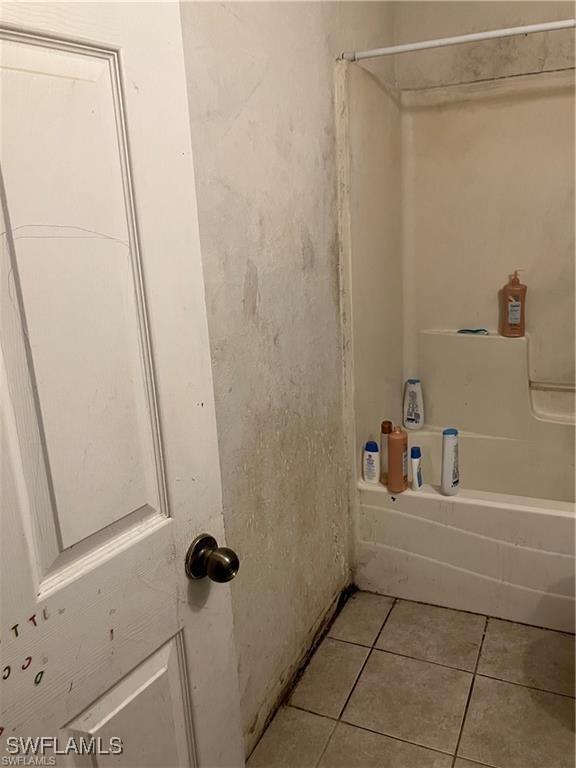 full bathroom featuring tile patterned flooring