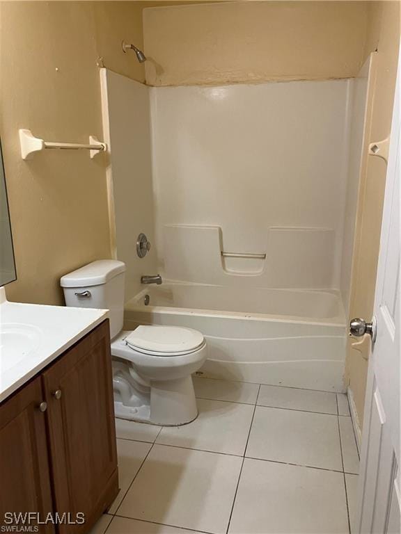 full bathroom featuring toilet, tile patterned flooring, washtub / shower combination, and vanity