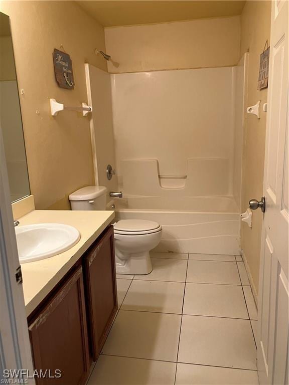 bathroom featuring tile patterned flooring, vanity, toilet, and bathing tub / shower combination