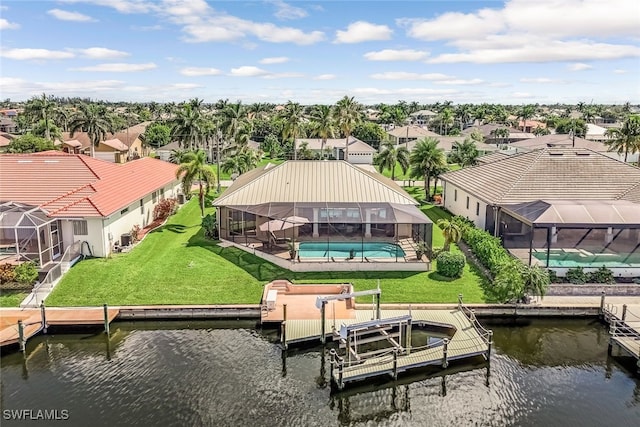 view of dock featuring a water view, a lawn, glass enclosure, a residential view, and an outdoor pool