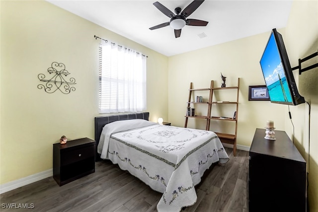 bedroom featuring ceiling fan, wood finished floors, and baseboards