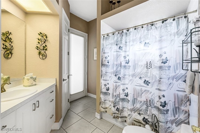 bathroom with tile patterned flooring, vanity, toilet, and shower / bath combo with shower curtain