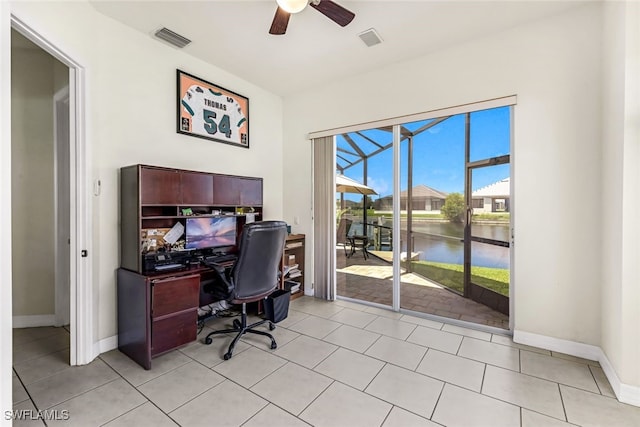 office space featuring visible vents, a ceiling fan, a sunroom, light tile patterned flooring, and baseboards