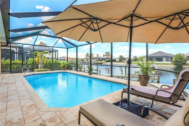 pool with a water view, glass enclosure, and a patio