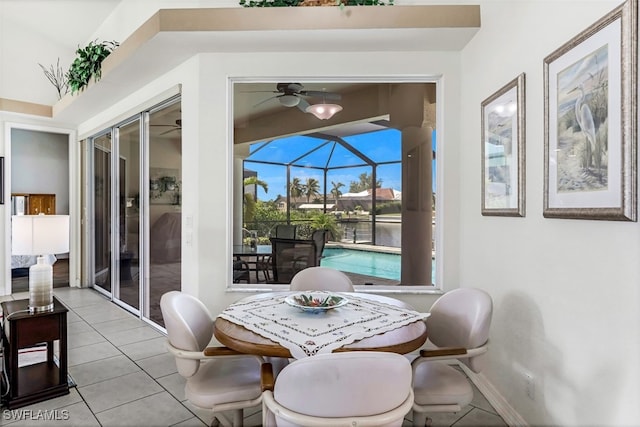 dining room featuring a sunroom, light tile patterned flooring, ceiling fan, and baseboards