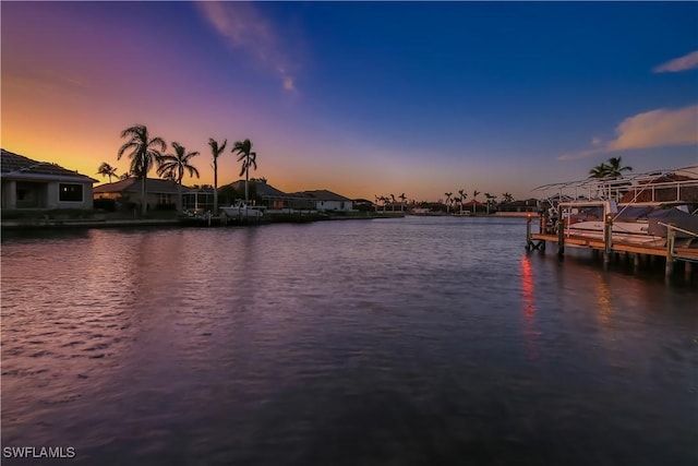 view of dock featuring a water view and a residential view