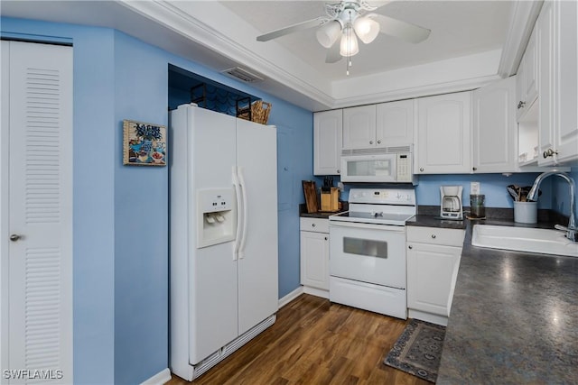 kitchen with white appliances, a sink, visible vents, white cabinetry, and dark countertops