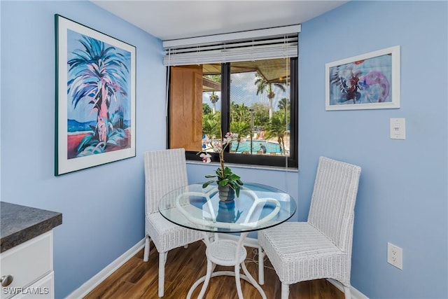 dining room with wood finished floors and baseboards