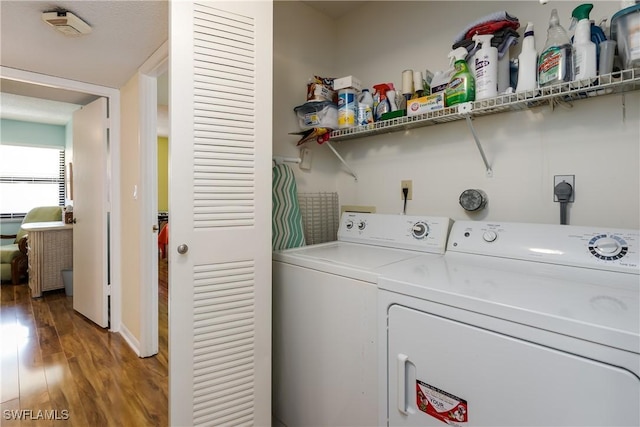 laundry area with light wood-style floors, laundry area, and separate washer and dryer