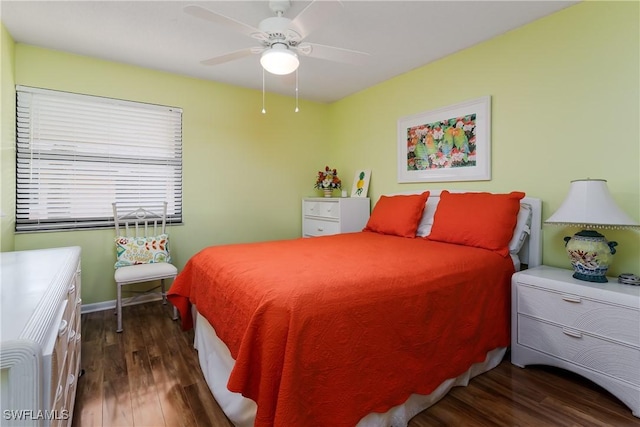 bedroom featuring dark wood-style floors, ceiling fan, and baseboards