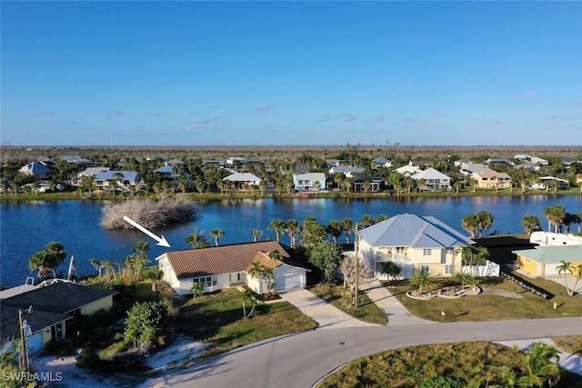 drone / aerial view featuring a water view and a residential view