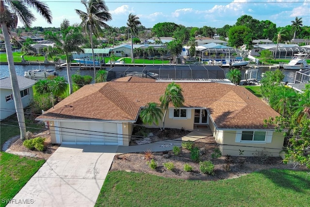 drone / aerial view featuring a water view and a residential view