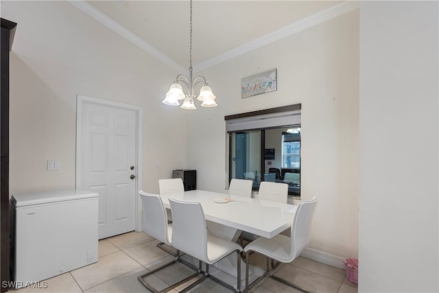 dining area with light tile patterned floors, ornamental molding, and a chandelier