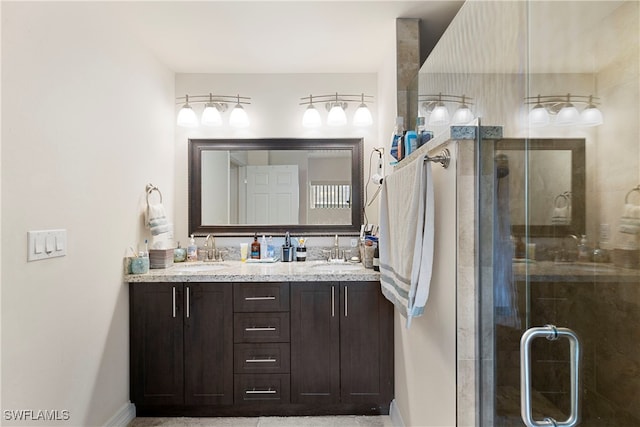 full bathroom featuring double vanity, a stall shower, and a sink