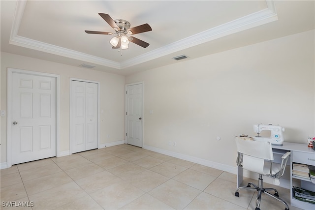 home office featuring light tile patterned floors, visible vents, a tray ceiling, and crown molding