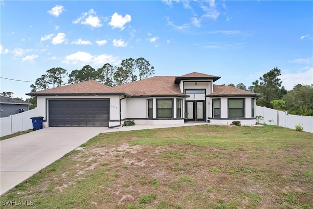 view of front of home with a garage, french doors, fence, and concrete driveway