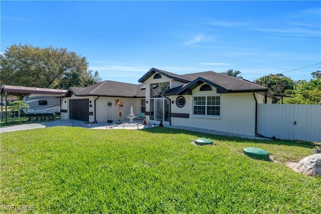 view of front facade featuring a garage, concrete driveway, fence, a front lawn, and stucco siding