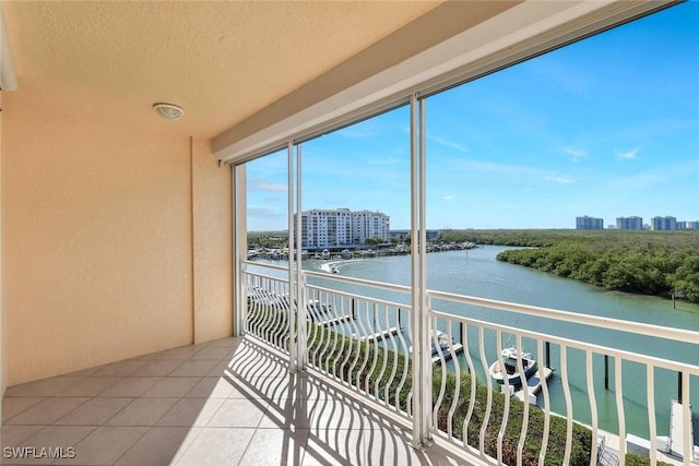 balcony featuring a view of city and a water view