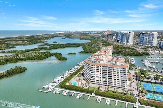 birds eye view of property with a city view and a water view