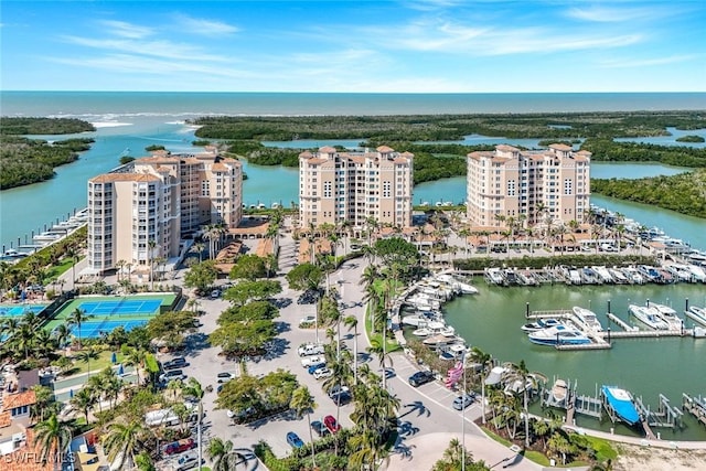 birds eye view of property featuring a city view and a water view