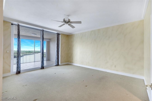 empty room with ceiling fan, baseboards, carpet, and ornamental molding