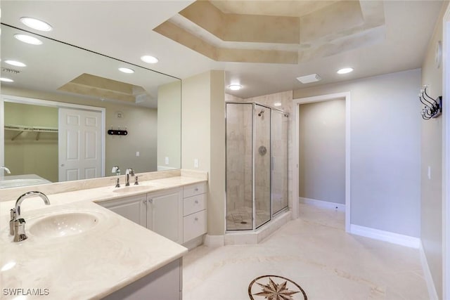 full bath featuring recessed lighting, a stall shower, baseboards, and a tray ceiling