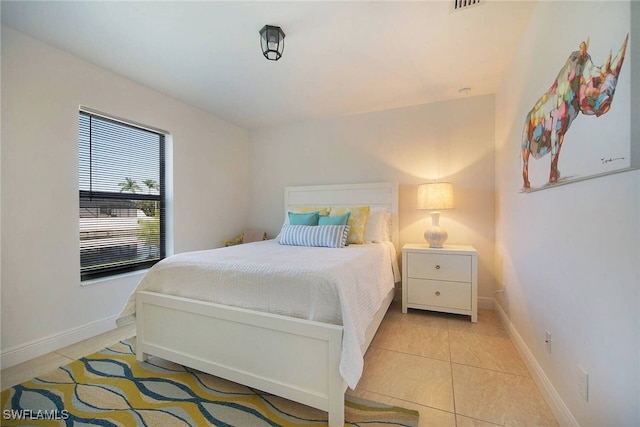 bedroom featuring light tile patterned flooring and baseboards