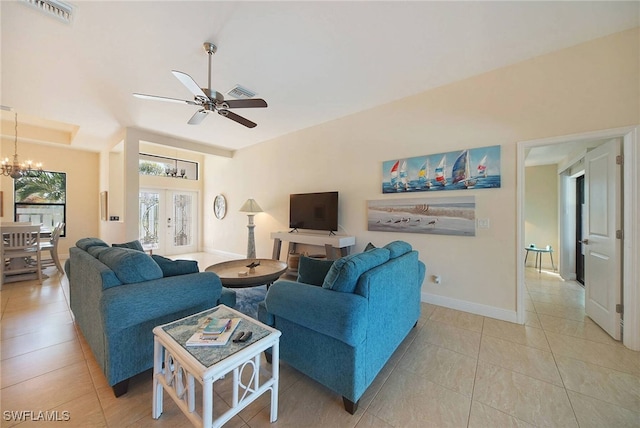 living room featuring ceiling fan with notable chandelier, french doors, visible vents, and baseboards