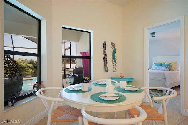 dining room featuring baseboards and light tile patterned floors